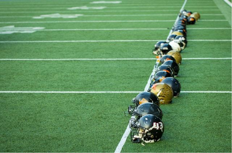 A line of football players lined up on the field